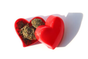 A photo of cannabis inside a heart-shaped box